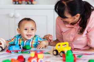 Key Carer and child playing with toy cars