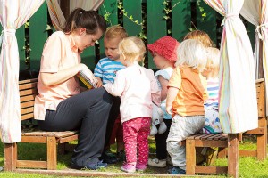 Key Carer reading to children outside