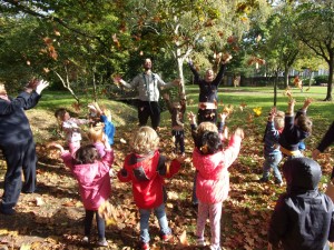Children having fun in autumn leaves