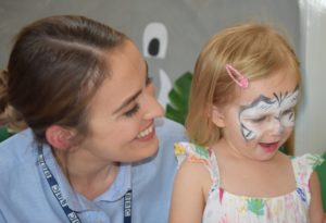 Staff member with child with face paints