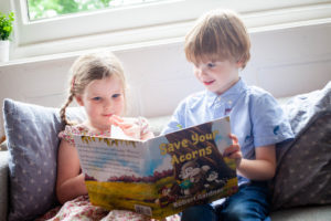 Children reading Save your Acorns