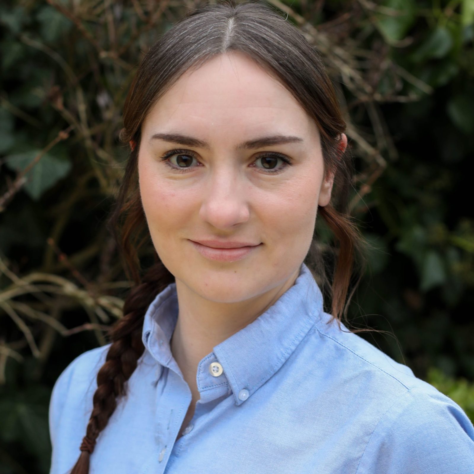 Acorns Nurseries A person with braided hair in a blue 