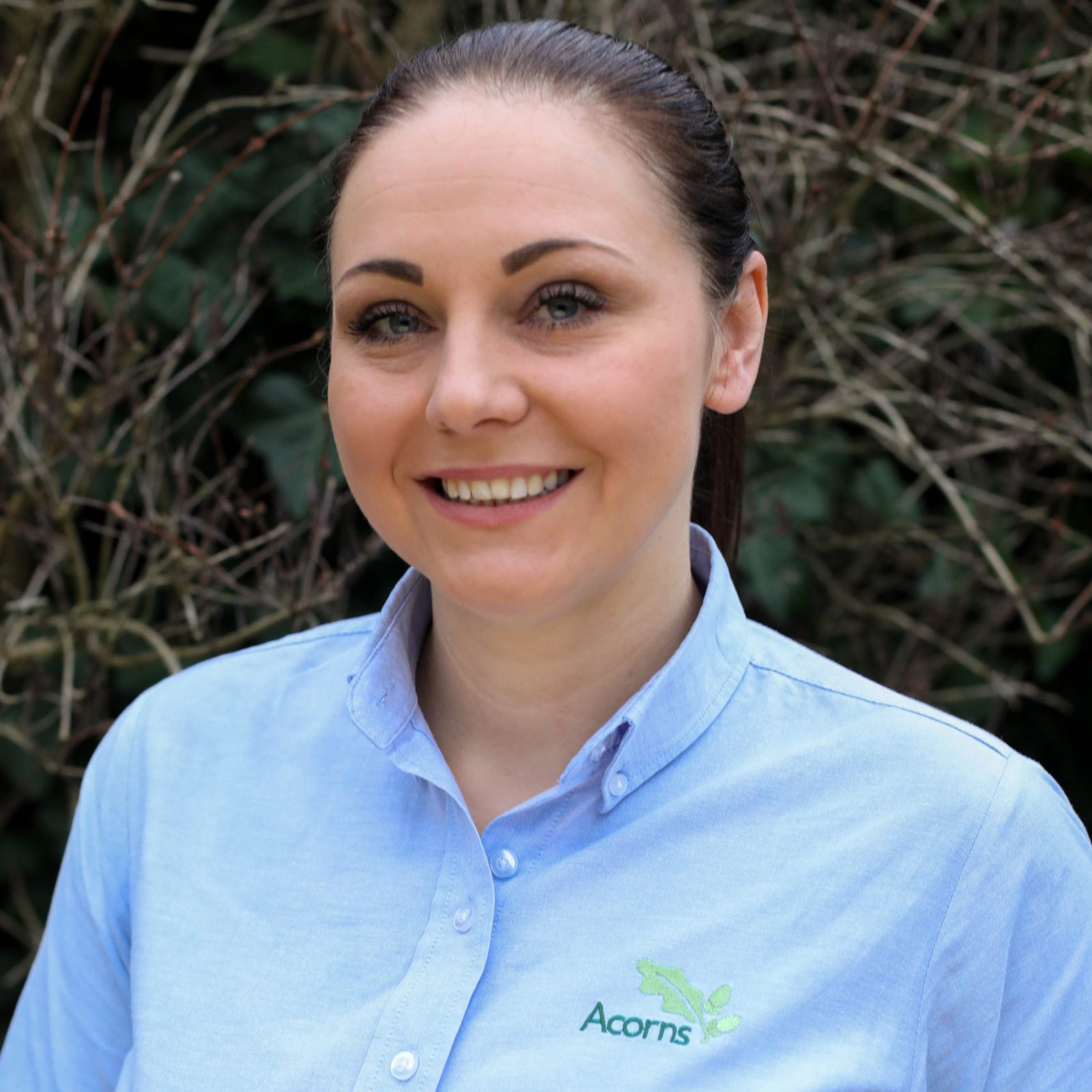 Acorns Nurseries A person in a light blue shirt with an 